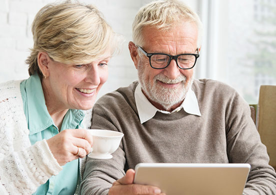 Senior couple using a tablet at home